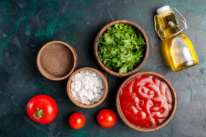 Ingredients for authentic marinara sauce on wooden table